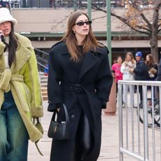 Hailey Bieber wearing a Saint Laurent maxi coat in Aspen