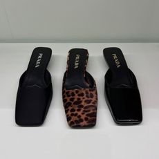 three pairs of Prada square-toe mules in black satin, leopard print, and black patent leather