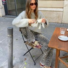 woman in leopard pants and sweater