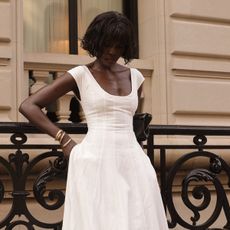 Amy Julliette Lefévre wearing a white scoop-neck fit-and-flare tea-length dress from Danielle Guizio. 