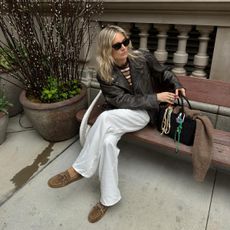 Lucy Williams wearing a leather biker jacket, trousers, and boat shoes.