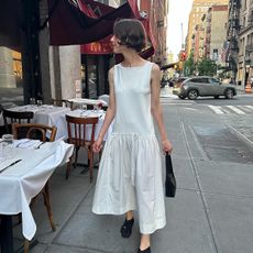 @alainaimperio wears a drop-waist dress from COS in NYC