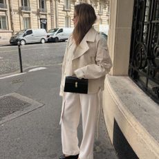 Influencer wears a cropped trench coat.